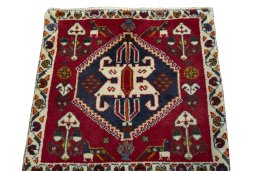 Surface texture of 2000s Shiraz rug with natural Wool and intricate pattern