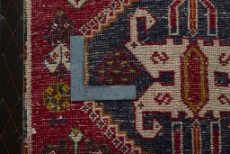 Backside of handmade 2000s Shiraz rug showing knot structure and weave density