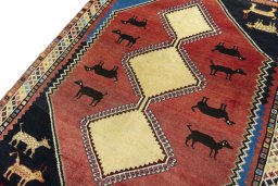 Backside of handmade 2000s Shiraz rug showing knot structure and weave density