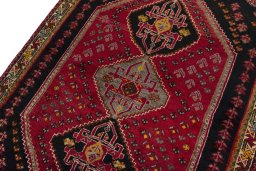 Backside of handmade 2000s Shiraz rug showing knot structure and weave density