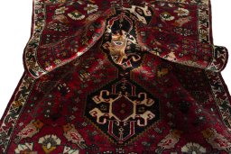 Corner detail of 2000s Shiraz rug showing border pattern and Wool pile