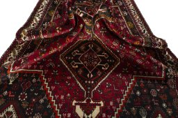 Corner detail of 2000s Shiraz rug showing border pattern and Wool pile
