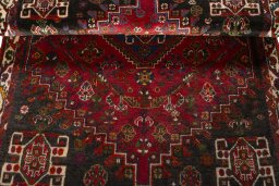 Corner detail of 2000s Shiraz rug showing border pattern and Wool pile