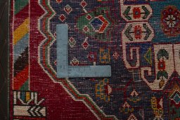 Backside of handmade 2000s Shiraz rug showing knot structure and weave density