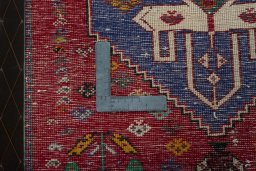 Backside of handmade 2000s Shiraz rug showing knot structure and weave density