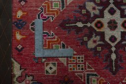 Backside of handmade 2000s Shiraz rug showing knot structure and weave density