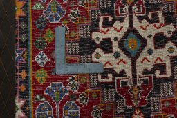 Backside of handmade 2000s Shiraz rug showing knot structure and weave density