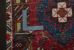 Backside of handmade 2000s Shiraz rug showing knot structure and weave density