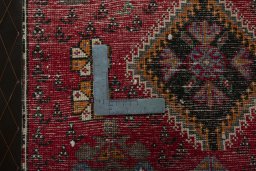 Backside of handmade 2000s Shiraz rug showing knot structure and weave density