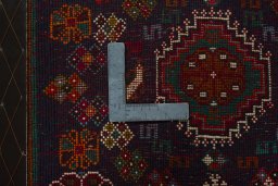 Backside of handmade 2000s Shiraz rug showing knot structure and weave density