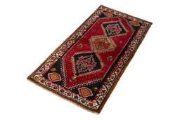 Corner detail of 2000s Shiraz rug showing border pattern and Wool pile