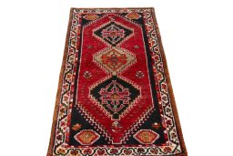 Surface texture of 2000s Shiraz rug with natural Wool and intricate pattern