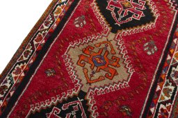 Backside of handmade 2000s Shiraz rug showing knot structure and weave density
