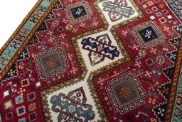 Backside of handmade 2000s Shiraz rug showing knot structure and weave density