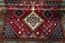 Full view of 2000s Shiraz rug from Iran / Persia, 200 × 139 cm in Red tones