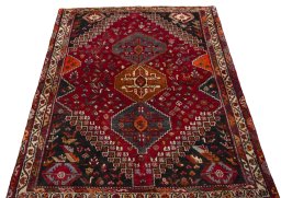 Surface texture of 2000s Shiraz rug with natural Wool and intricate pattern