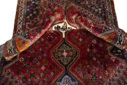 Corner detail of 2000s Shiraz rug showing border pattern and Wool pile