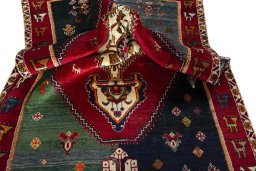 Corner detail of 2000s Shiraz rug showing border pattern and Wool pile