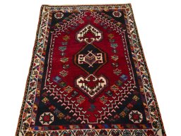 Surface texture of 2000s Shiraz rug with natural Wool and intricate pattern