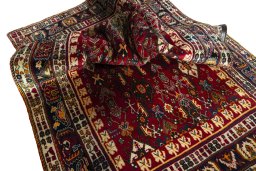 Corner detail of 2000s Shiraz rug showing border pattern and Wool pile