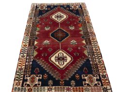 Surface texture of 2000s Shiraz rug with natural Wool and intricate pattern