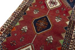 Backside of handmade 2000s Shiraz rug showing knot structure and weave density