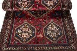 Corner detail of 2000s Shiraz rug showing border pattern and Wool pile