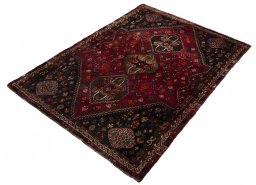 Corner detail of 2000s Shiraz rug showing border pattern and Wool pile