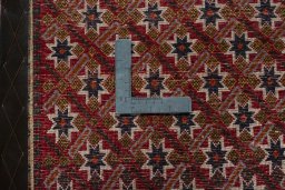Backside of handmade 2000s Shiraz rug showing knot structure and weave density