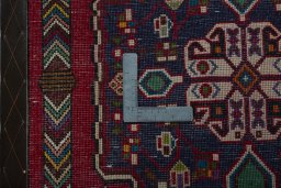 Backside of handmade 2000s Shiraz rug showing knot structure and weave density