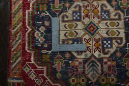 Backside of handmade 2000s Shiraz rug showing knot structure and weave density