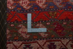 Backside of handmade 2000s Shiraz rug showing knot structure and weave density