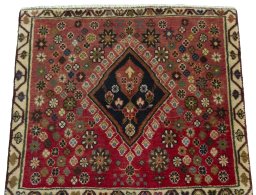 Surface texture of 2000s Shiraz rug with natural Wool and intricate pattern