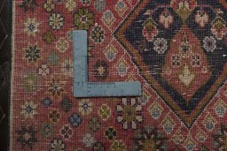 Backside of handmade 2000s Shiraz rug showing knot structure and weave density