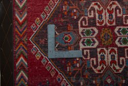 Backside of handmade 2000s Shiraz rug showing knot structure and weave density