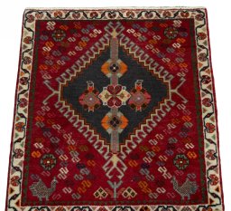 Surface texture of 2000s Shiraz rug with natural Wool and intricate pattern