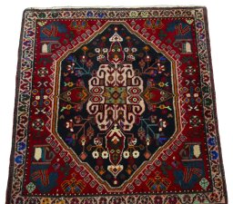 Surface texture of 2000s Shiraz rug with natural Wool and intricate pattern