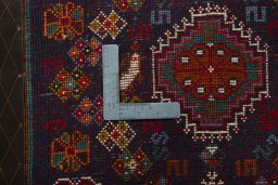 Backside of handmade 2000s Shiraz rug showing knot structure and weave density