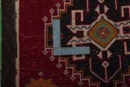 Backside of handmade 2000s Shiraz rug showing knot structure and weave density