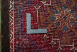 Backside of handmade 2000s Shiraz rug showing knot structure and weave density
