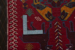 Backside of handmade 2000s Shiraz rug showing knot structure and weave density