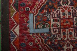 Backside of handmade 2000s Shiraz rug showing knot structure and weave density