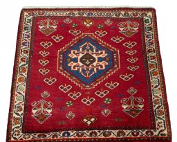 Surface texture of 2000s Shiraz rug with natural Wool and intricate pattern