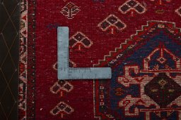 Backside of handmade 2000s Shiraz rug showing knot structure and weave density