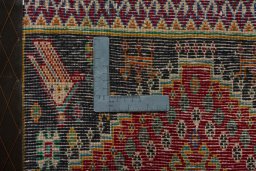 Backside of handmade 2000s Shiraz rug showing knot structure and weave density