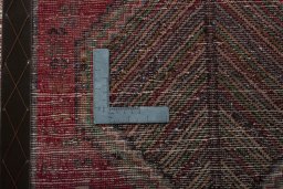 Backside of handmade 2000s Shiraz rug showing knot structure and weave density