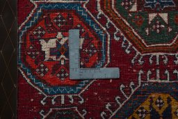 Backside of handmade 2000s Shiraz rug showing knot structure and weave density