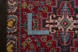 Backside of handmade 2000s Shiraz rug showing knot structure and weave density