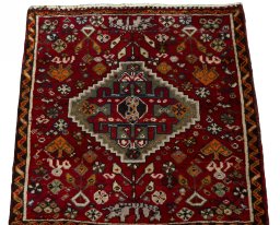 Surface texture of 2000s Shiraz rug with natural Wool and intricate pattern