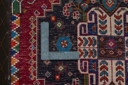 Backside of handmade 2000s Shiraz rug showing knot structure and weave density